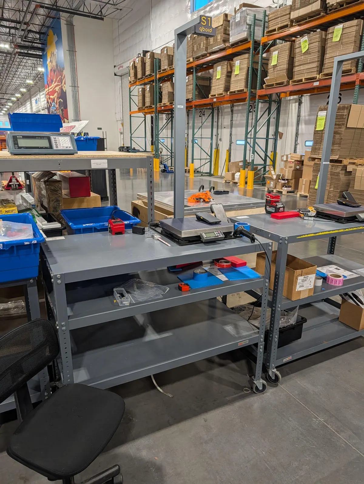 S1 on a rolling workbench at a receiving area, with a laptop beside it