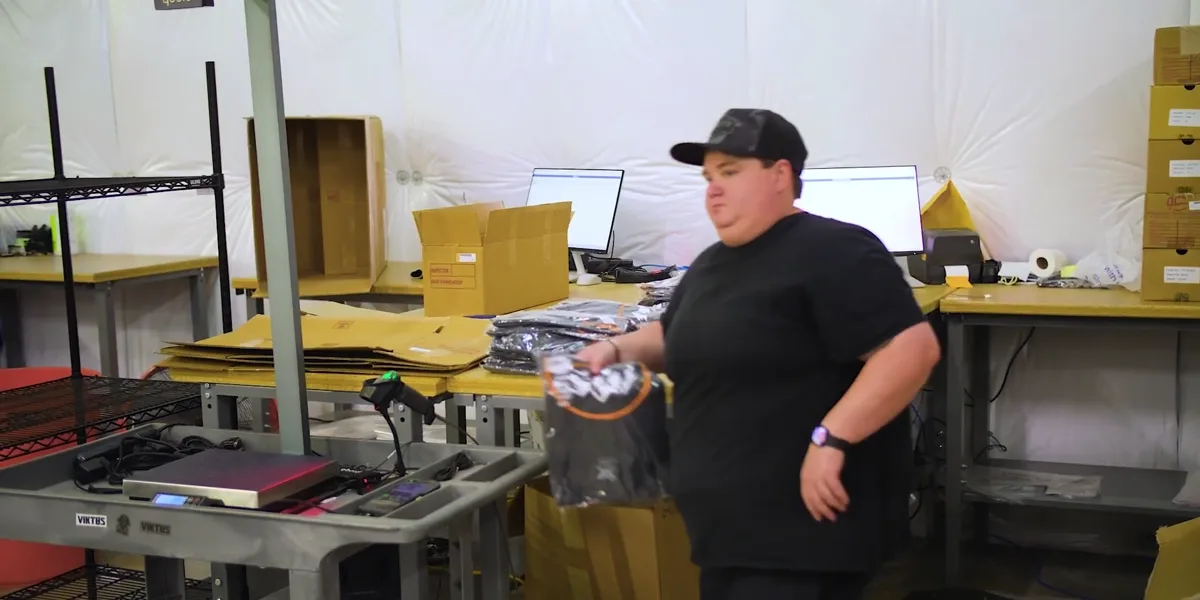 A Weby Corp associate at the receiving bench next to the S1 and the M2